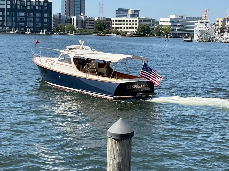 The Image of 2001 Hinckley Classic 36 Picnic Boat cruising in urban waterfront setting. - 0