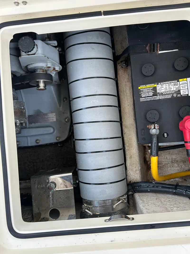 Slide: The Image of Engine compartment of a 2001 Hinckley Classic 36 Picnic Boat, showing mechanical components and wiring. - 12