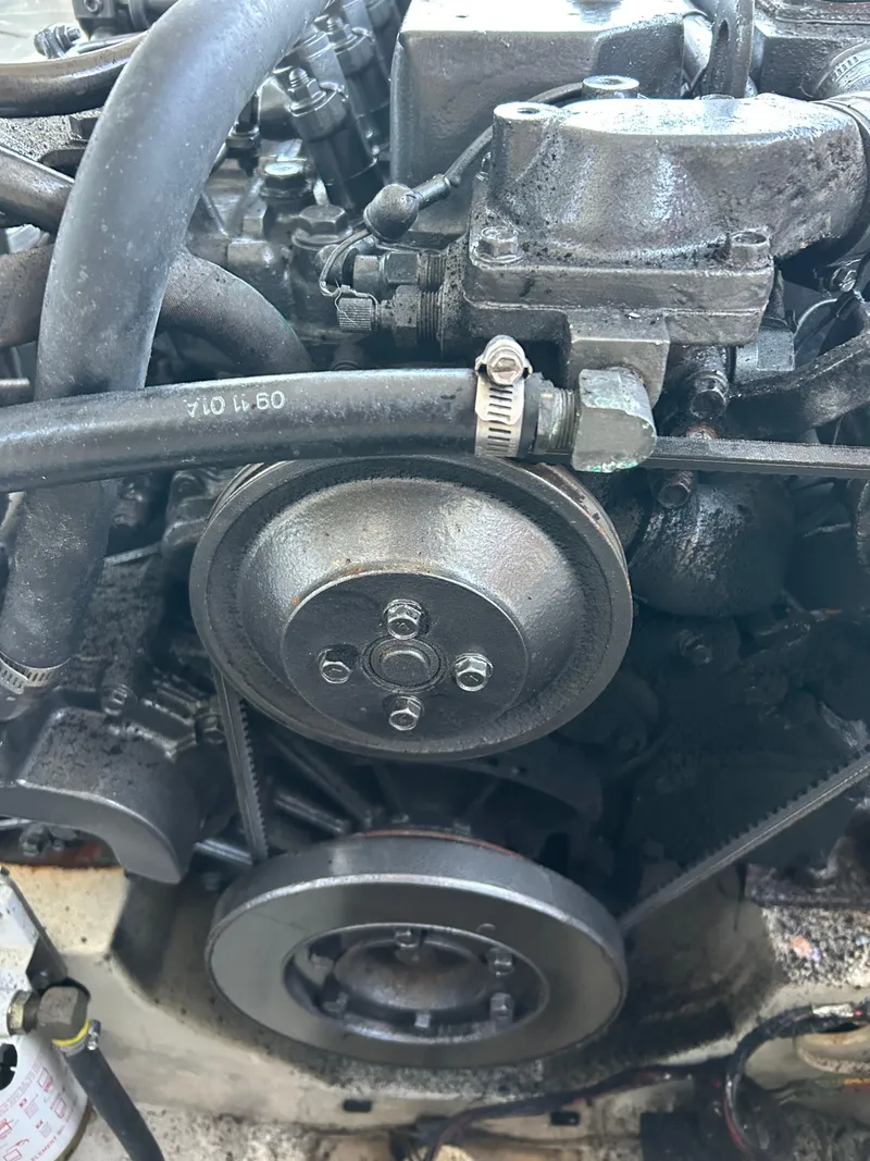 Slide: The Image of Engine of 2001 Hinckley Classic 36 Picnic Boat, showcasing mechanical components and hoses. - 16