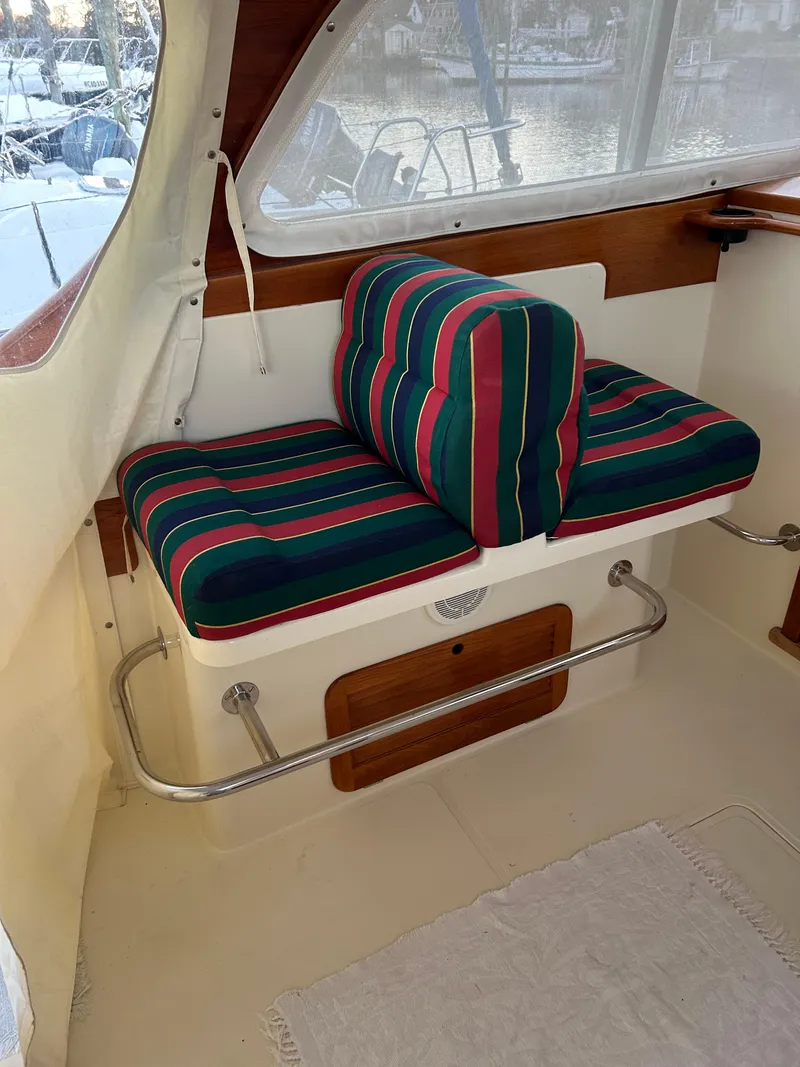Slide: The Image of Interior seating of 2001 Hinckley Classic 36 Picnic Boat with striped cushions. - 27