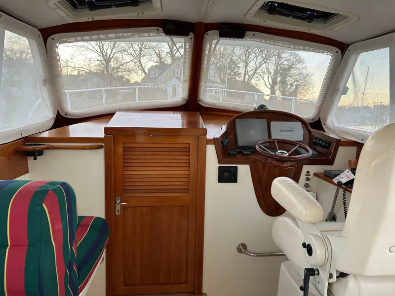 Slide: The Image of Interior of a 2001 Hinckley Classic 36 Picnic Boat with helm and seating. - 28
