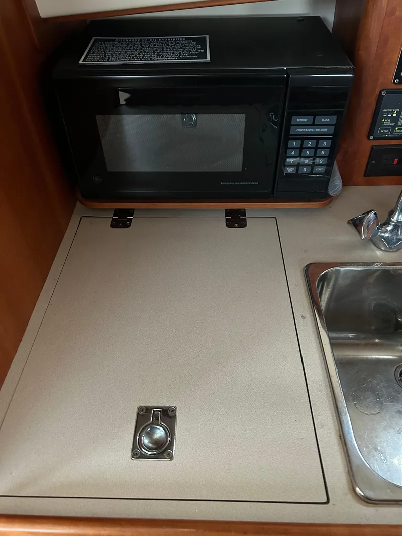 Slide: The Image of 2001 Hinckley Classic 36 Picnic Boat galley with microwave and sink. - 32