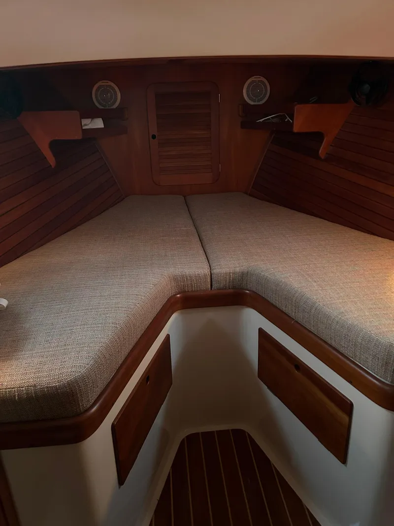 Slide: The Image of 2001 Hinckley Classic 36 Picnic Boat interior with cozy V-berth and wooden accents. - 34