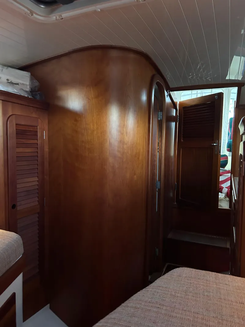 Slide: The Image of Interior of 2001 Hinckley Classic 36 Picnic Boat with wooden cabinetry and cozy seating. - 38