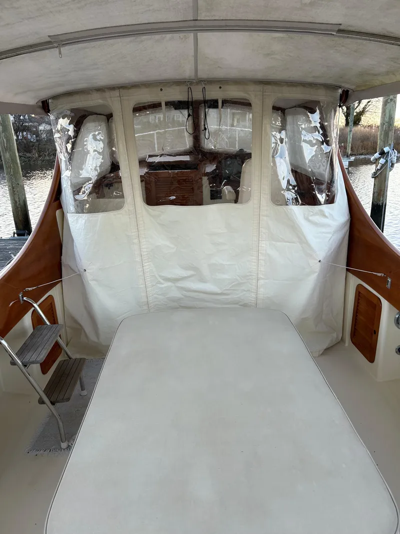 Slide: The Image of 2001 Hinckley Classic 36 Picnic Boat interior with covered seating area. - 10
