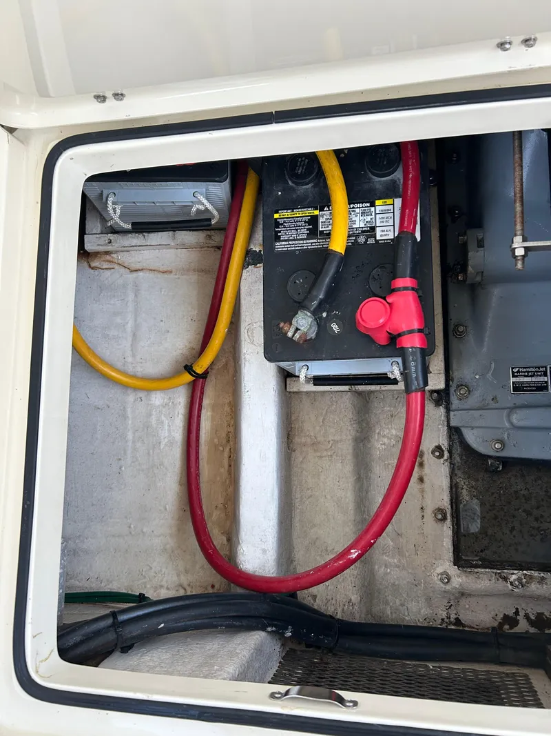 Slide: The Image of Battery compartment of a 2001 Hinckley Classic 36 Picnic Boat with visible cables. - 11