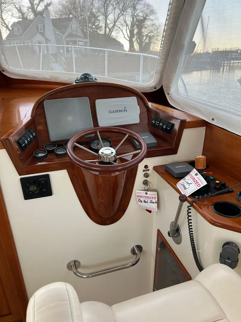Slide: The Image of 2001 Hinckley Classic 36 Picnic Boat helm with wooden steering wheel and navigation equipment. - 19