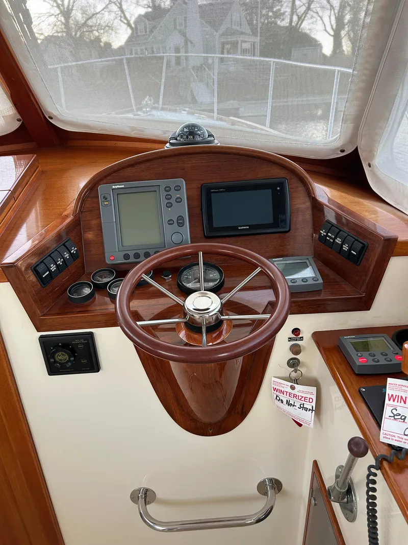 Slide: The Image of Helm of 2001 Hinckley Classic 36 Picnic Boat with navigation instruments and wooden steering wheel. - 20
