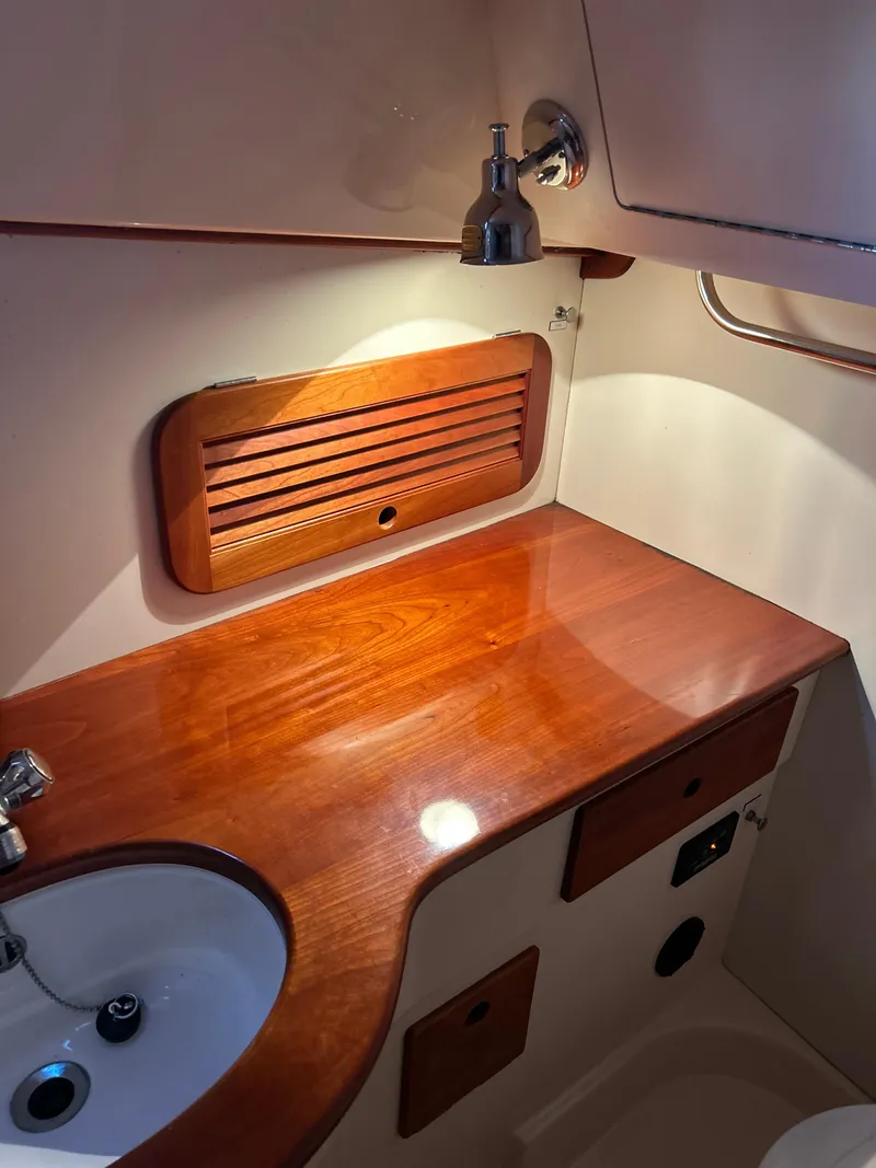 Slide: The Image of 2001 Hinckley Classic 36 Picnic Boat interior with wooden countertop and sink. - 43