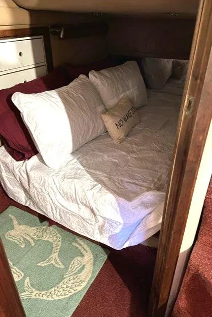 Slide: The Image of Cozy bedroom in 1988 Regal 360 XL Commodore yacht, featuring comfortable bedding and nautical decor. - 10