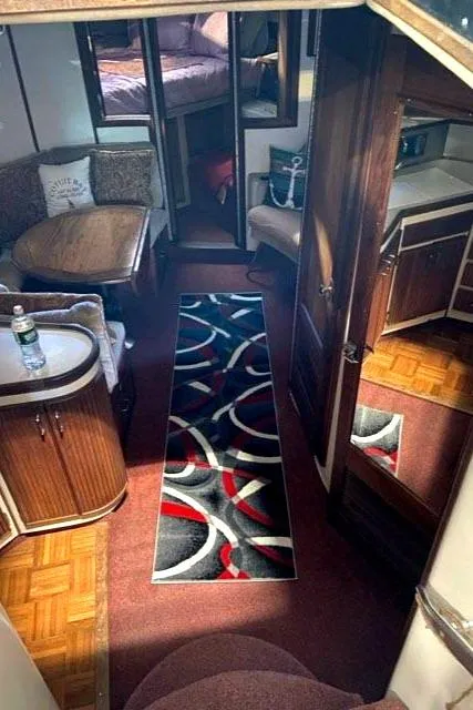 Slide: The Image of 1988 Regal 360 XL Commodore interior with modern updates, featuring stylish decor and cozy seating. - 11