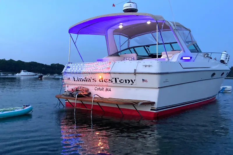 Slide: The Image of 1988 Regal 360 XL Commodore boat docked at sunset, featuring updated design and vibrant lighting. - 15