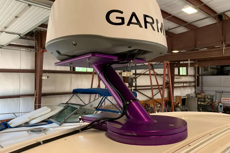 Slide: The Image of Radar equipment on 1988 Regal 360 XL Commodore boat, featuring a purple mount in a warehouse. - 17