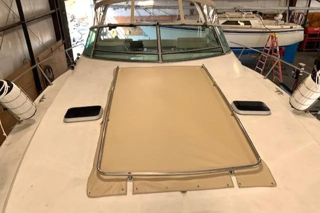 Slide: The Image of 1988 Regal 360 XL Commodore boat with updated features, docked indoors. - 28