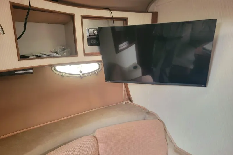 Slide: The Image of Interior of a 1988 Regal Commodore 360 boat with mounted TV and storage compartments. - 33