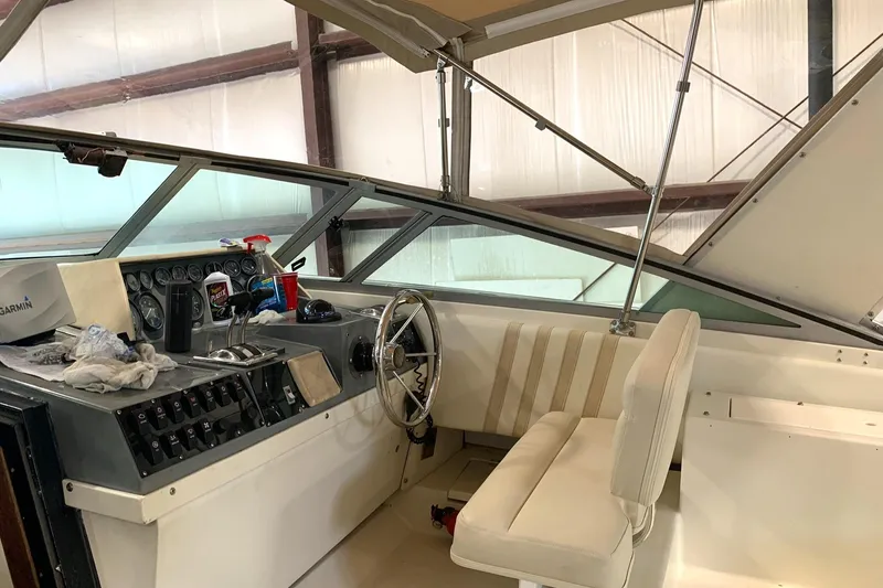 Slide: The Image of 1988 Regal 360 XL Commodore helm with updated controls and seating in a covered area. - 4