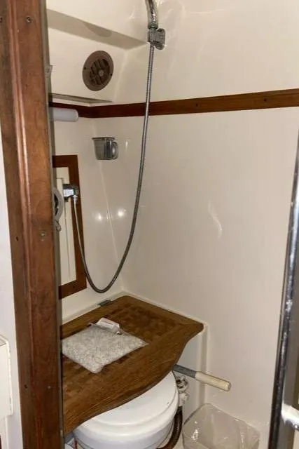 Slide: The Image of 1988 Regal 360 XL Commodore bathroom with shower, wood accents, and modern updates. - 9