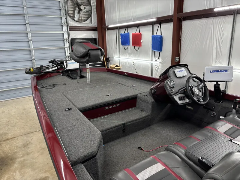 Slide: The Image of 2019 Ranger RT178 boat interior with Lowrance electronics in a garage setting. - 11