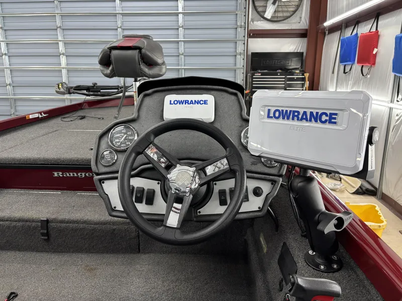 Slide: The Image of 2019 Ranger RT178 boat dashboard with Lowrance electronics and steering wheel in a garage setting. - 14