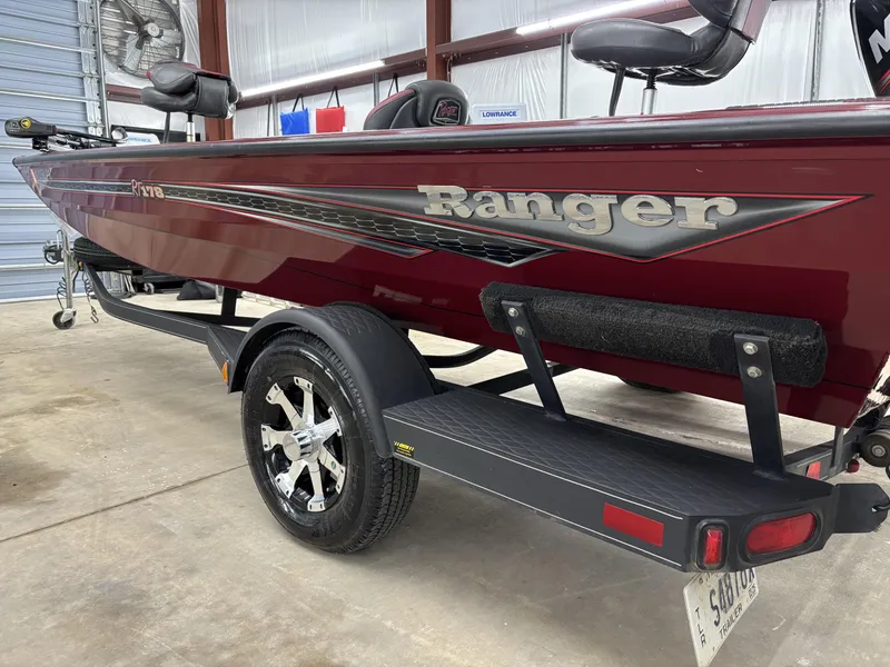 Slide: The Image of 2019 Ranger RT178 boat in a garage, featuring a sleek maroon design and trailer. - 3