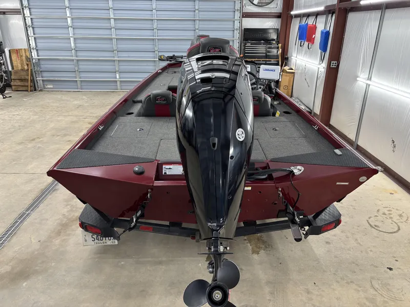 Slide: The Image of 2019 Ranger RT178 boat in garage, rear view with motor, red and black design. - 5