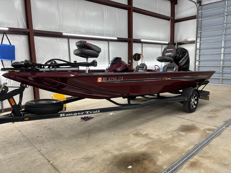 Slide: The Image of 2019 Ranger RT178 boat in a garage, on a Ranger Trail trailer. - 7