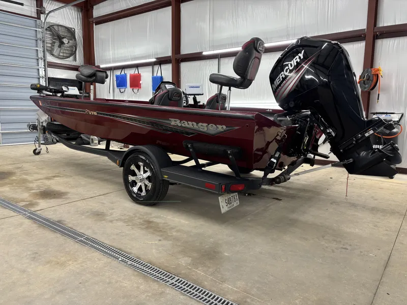 Slide: The Image of 2019 Ranger RT178 boat with Mercury engine in a garage setting. - 9