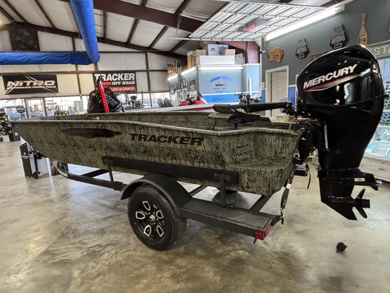 Slide: The Image of 2025 Tracker 1650 Prairie Wings Edition boat with Mercury engine in showroom. - 3