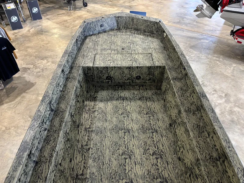 Slide: The Image of 2025 Tracker 1650 Prairie Wings Edition boat with camouflage interior in showroom. - 5