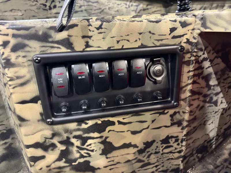 Slide: The Image of Control panel of 2025 Tracker 1650 Prairie Wings Edition with camo design and switches. - 6