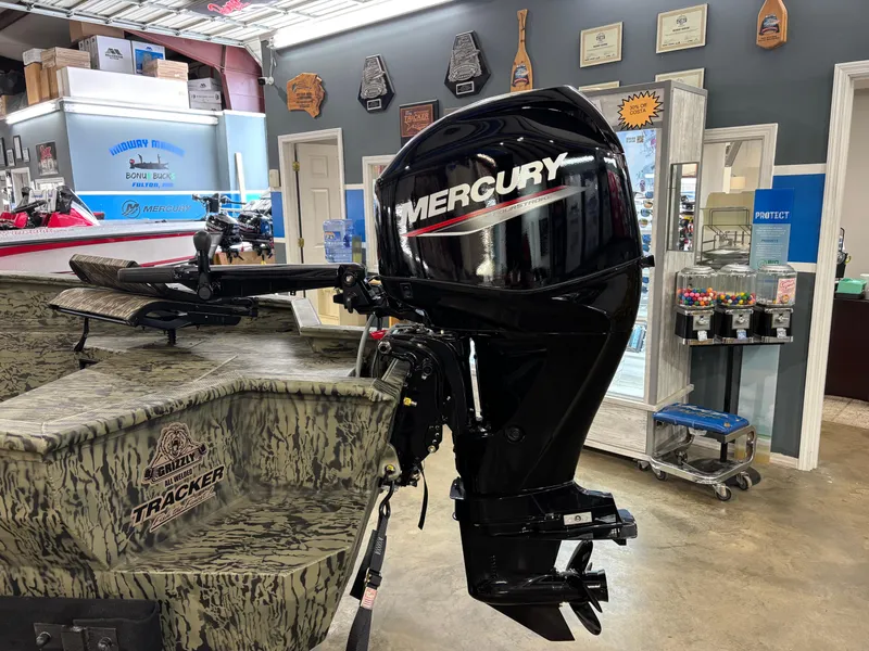 Slide: The Image of 2025 Tracker 1650 Prairie Wings Edition boat with Mercury outboard motor in showroom. - 8