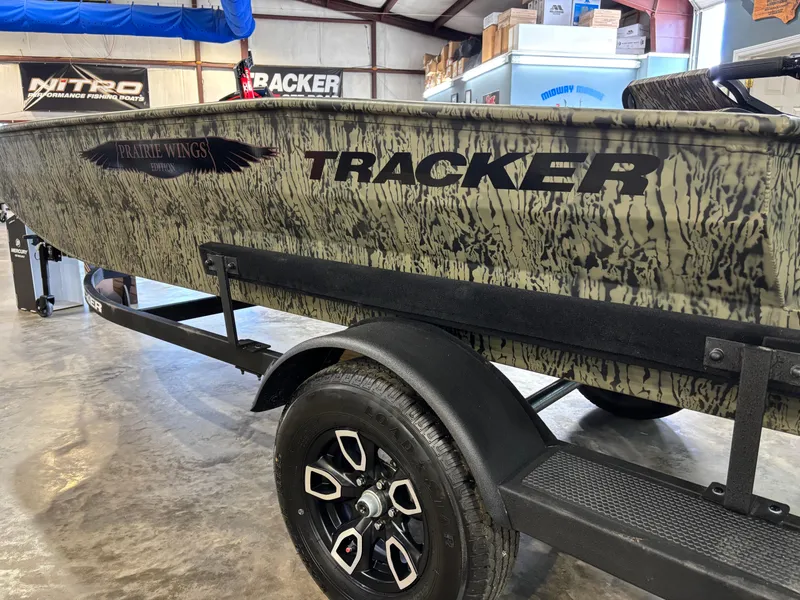 Slide: The Image of 2025 Tracker 1650 Prairie Wings Edition boat with camouflage design on trailer. - 9