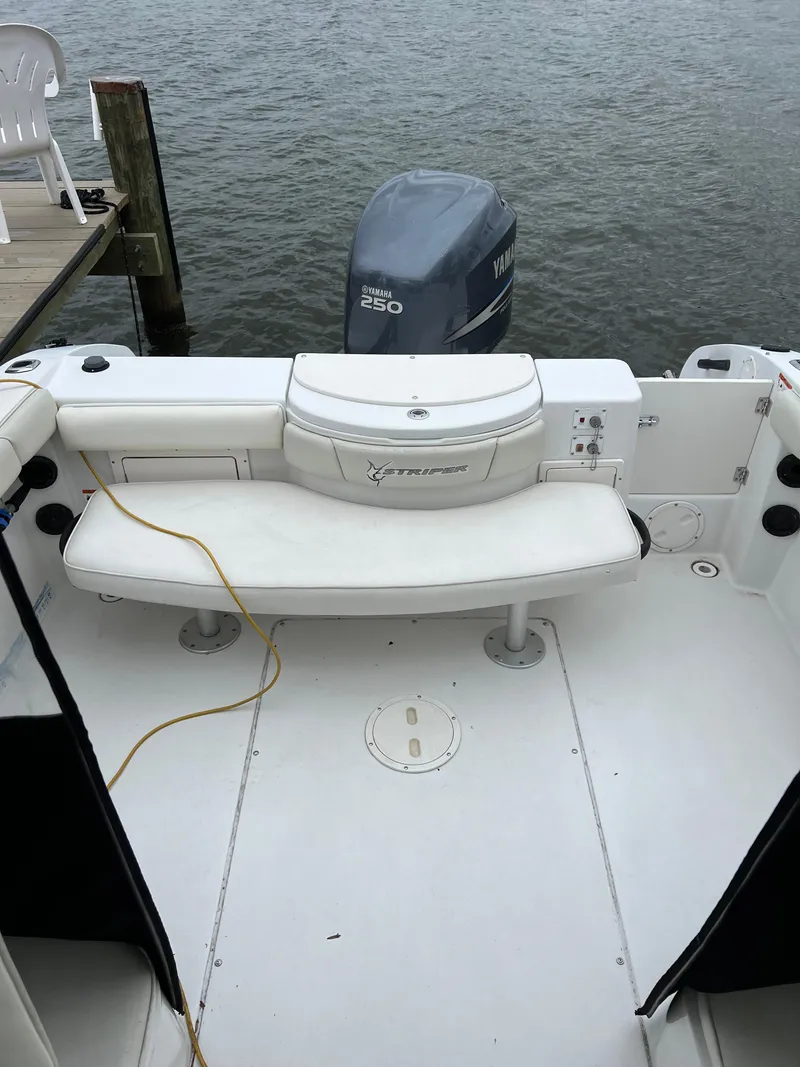 Slide: The Image of 2003 Seaswirl Striper 2301 Walkaround OB boat with Yamaha 250 engine, docked by the water. - 10