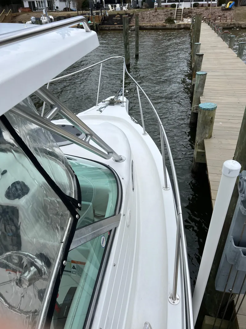 Slide: The Image of 2003 Seaswirl Striper 2301 Walkaround OB docked by wooden pier. - 12