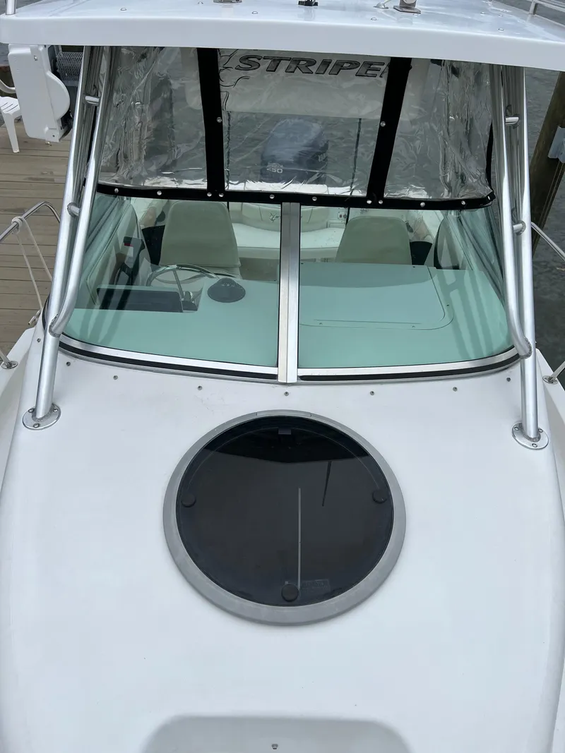 Slide: The Image of 2003 Seaswirl Striper 2301 Walkaround OB boat, featuring a sleek white exterior and circular hatch. - 15