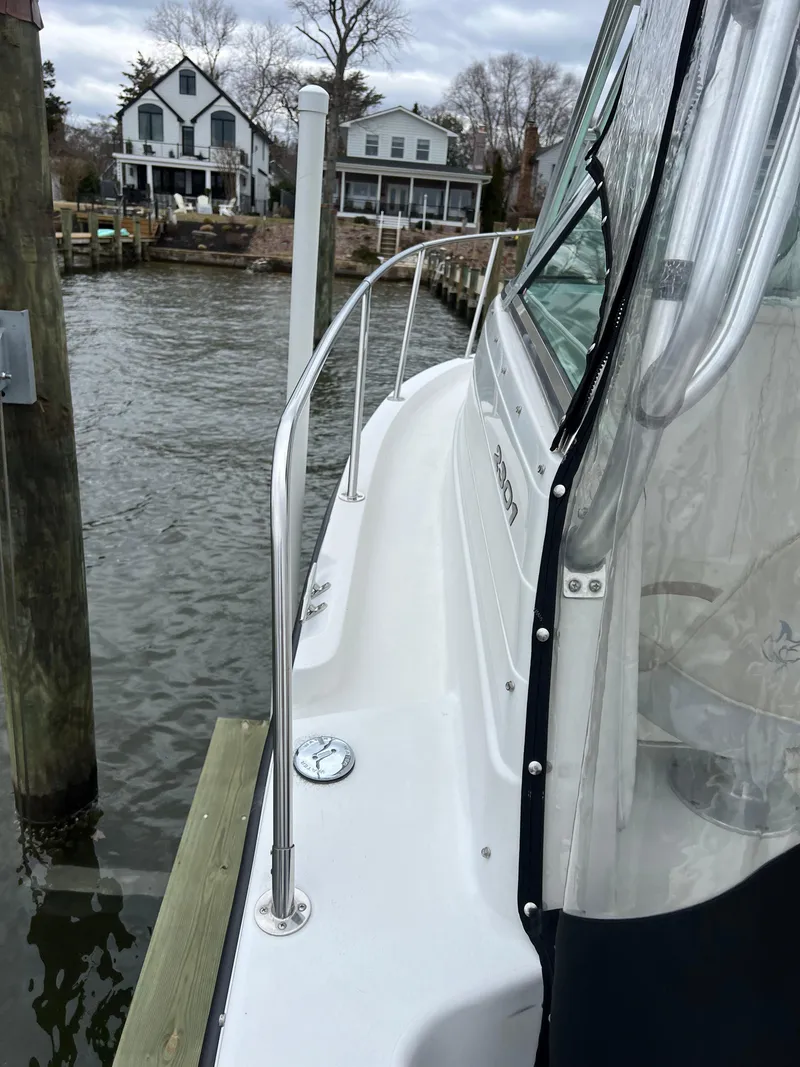 Slide: The Image of 2003 Seaswirl Striper 2301 Walkaround OB docked near waterfront homes. - 18