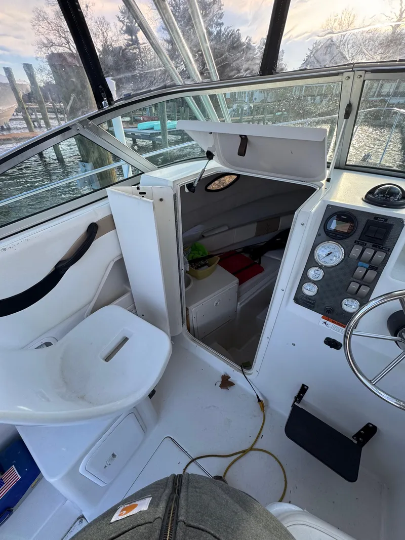 Slide: The Image of 2003 Seaswirl Striper 2301 Walkaround OB boat interior with seating and control panel. - 21