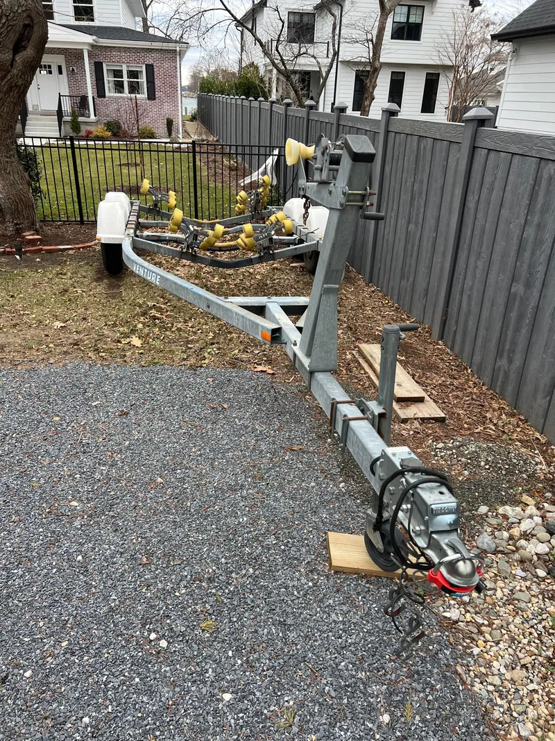 Slide: The Image of Boat trailer for 2003 Seaswirl Striper 2301 Walkaround OB, parked on gravel driveway. - 23