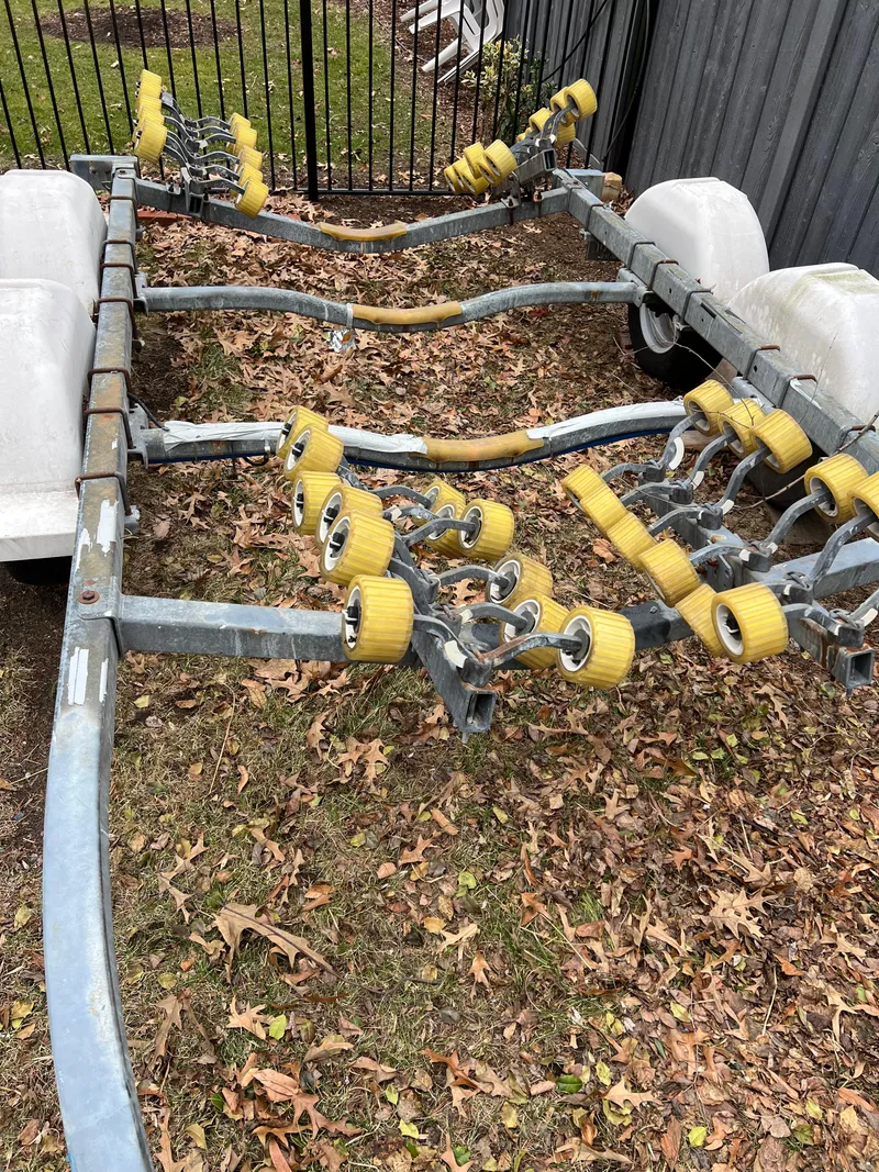 Slide: The Image of Boat trailer for 2003 Seaswirl Striper 2301 Walkaround OB, parked on leafy ground. - 24