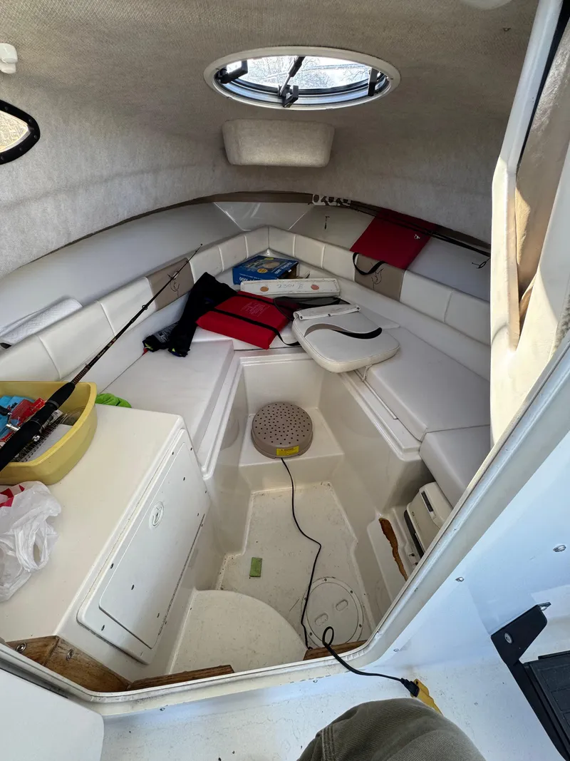 Slide: The Image of 2003 Seaswirl Striper 2301 Walkaround OB cabin interior with seating and storage. - 6