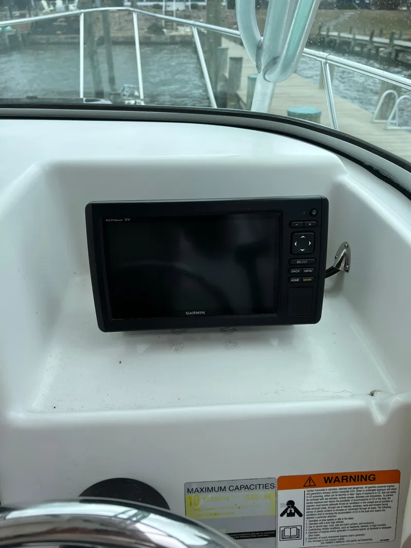 Slide: The Image of 2003 Seaswirl Striper 2301 Walkaround OB dashboard with navigation display. - 8