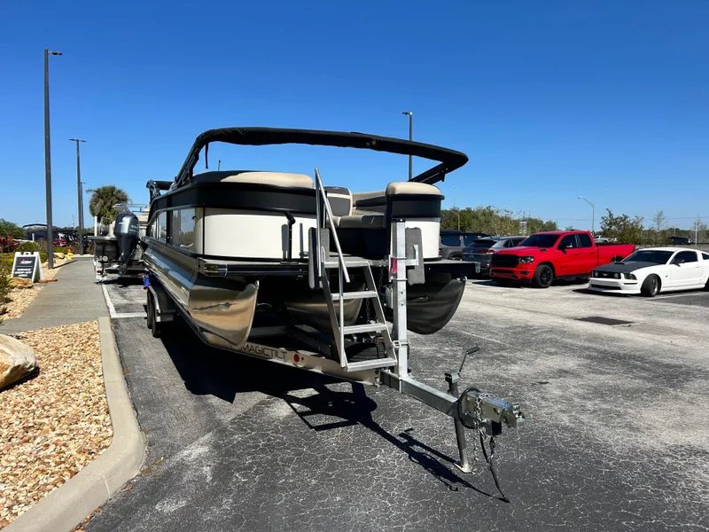 Slide: The Image of 2022 Barletta C24UC pontoon boat on trailer in parking lot, sunny day. - 10