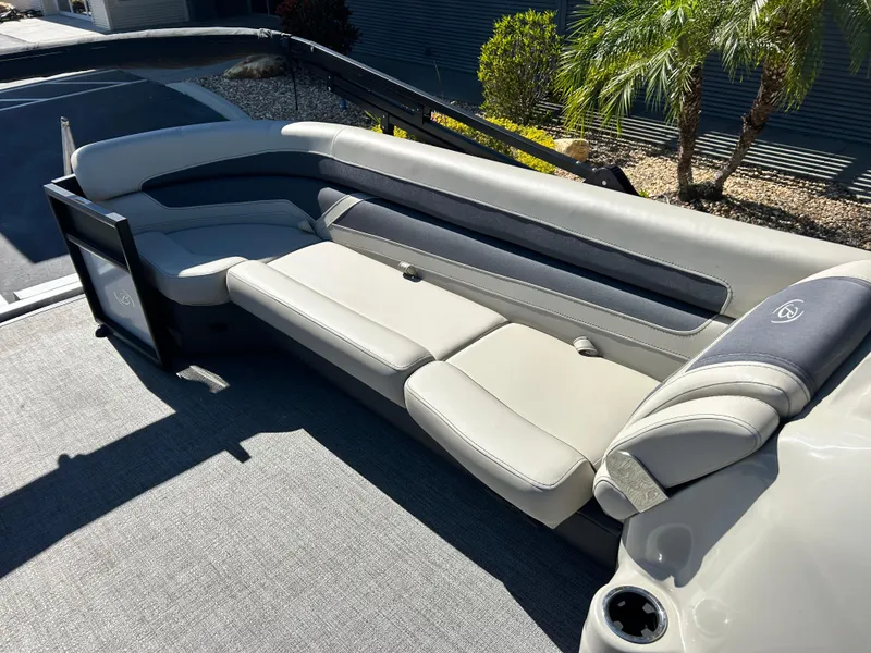 Slide: The Image of 2022 Barletta C24UC boat interior with gray seating and cup holder. - 3