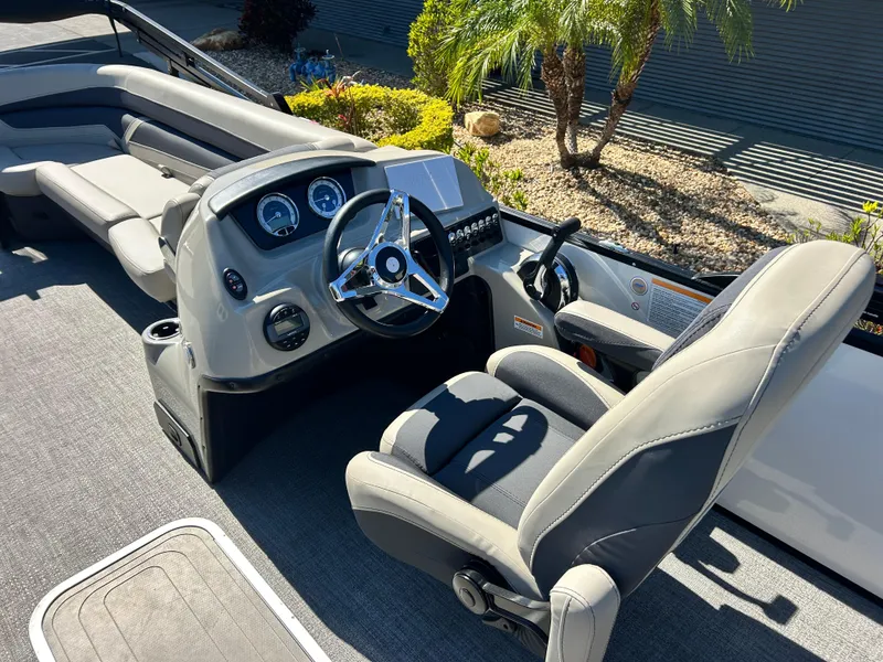 Slide: The Image of 2022 Barletta C24UC boat interior with steering wheel and seating. - 5
