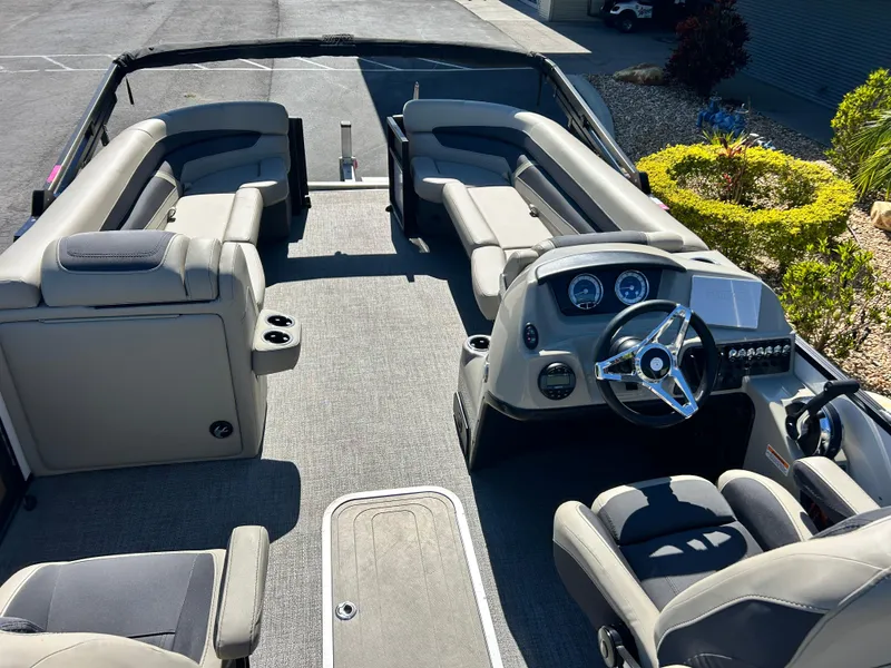 Slide: The Image of 2022 Barletta C24UC pontoon boat interior with steering console and seating. - 6
