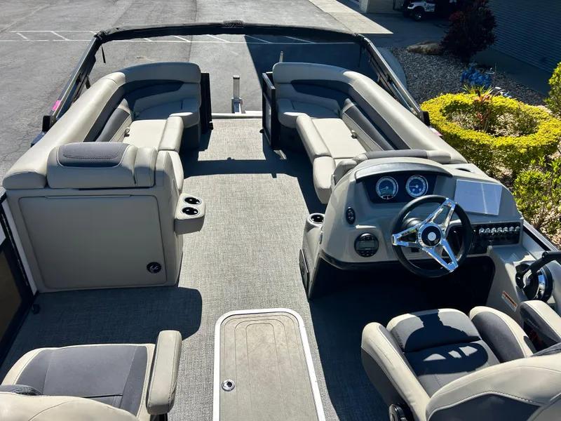 Slide: The Image of 2022 Barletta C24UC pontoon boat interior with plush seating and modern dashboard. - 7