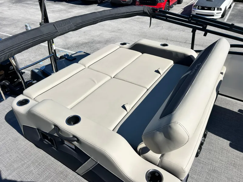 Slide: The Image of 2022 Barletta C24UC boat with beige seating and cup holders on deck. - 8