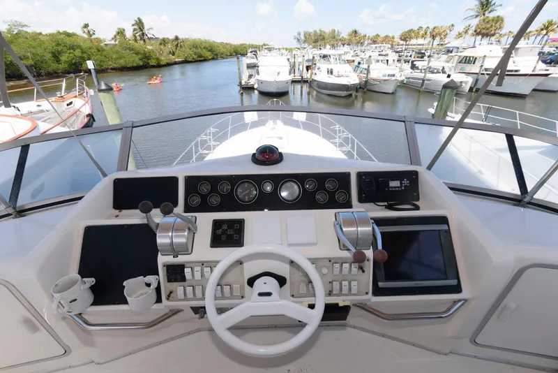 Slide: The Image of Cockpit view of 1995 Sea Ray 500 Sedan Bridge yacht at marina. - 12