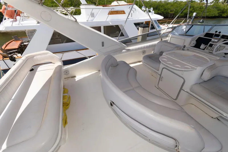 Slide: The Image of 1995 Sea Ray 500 Sedan Bridge yacht interior with white seating and control panel. - 13