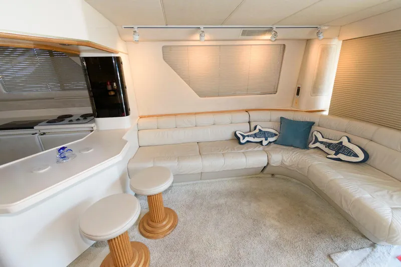 Slide: The Image of Luxurious interior of 1995 Sea Ray 500 Sedan Bridge with plush seating and nautical decor. - 17